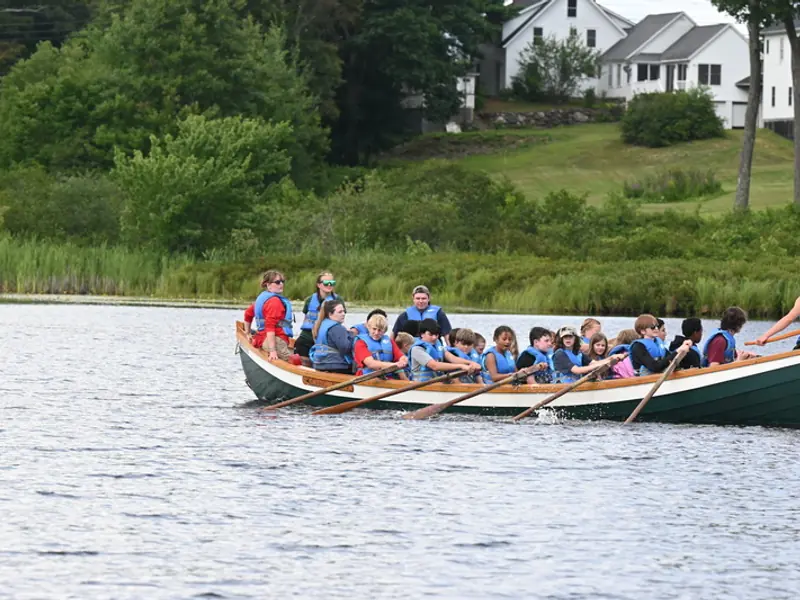 A canoe full of campers crossing Northwood Lake